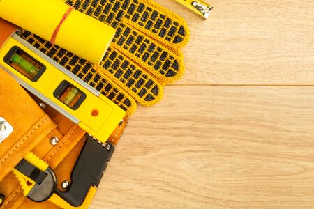 Protective equipment and tools in a bag for the builder on a wooden