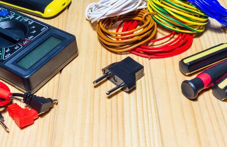 Tools and spare parts for electrician - wiring, tester, screwdrivers on wooden boards.の写真素材
