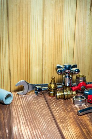 Different plumbing supplies and tools on wooden vintageの写真素材