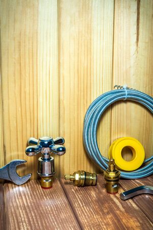 Different plumbing supplies and tools on wooden vintageの写真素材