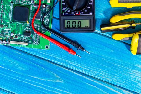 Services for the production of electronics and repair on a wooden blue