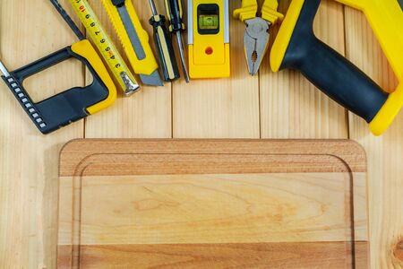 Saw and gloves for the Builder on a natural wooden  with free space for advertising.