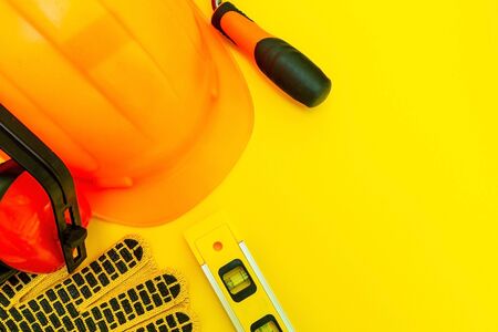 Protective equipment and tools in a bag for the builder on a yellowの写真素材