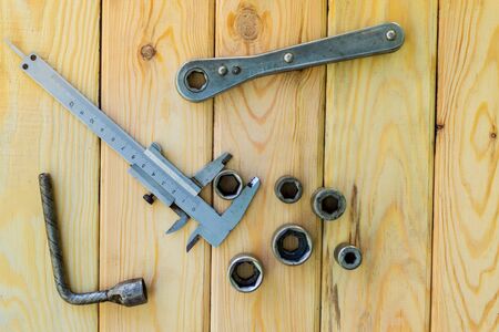 Rusty old tools are laid out on a woodenの写真素材