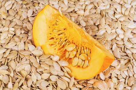 Background of pumpkin seeds and cut pumpkin after drying for foodの写真素材
