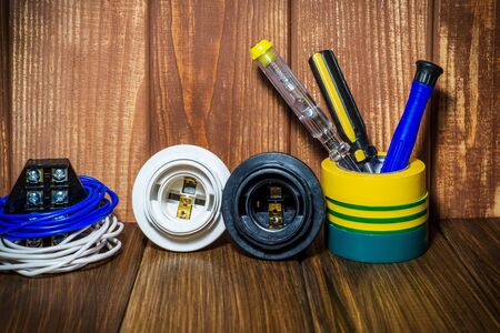Tools and accessories on a vintage wooden background used in electrical installations