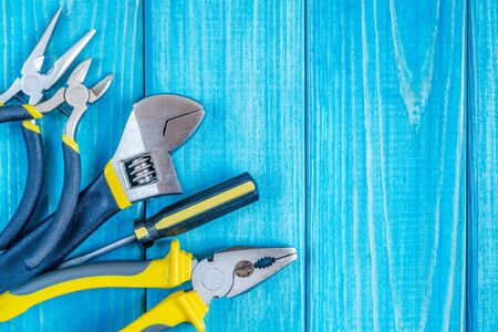 Tools for master builder and accessories set on blue wooden vintage background for the master...