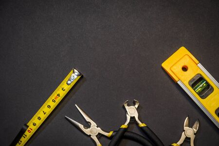 Tools for master builder prepared before work on black background with place for advertisingの写真素材