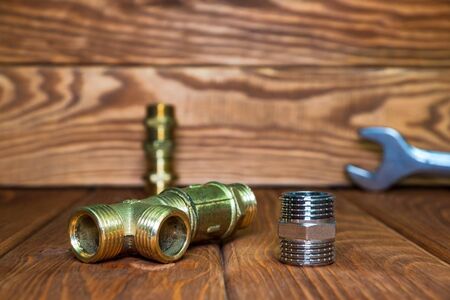 Set of brass fittings is often used to connect for water and gas installations on the background of...