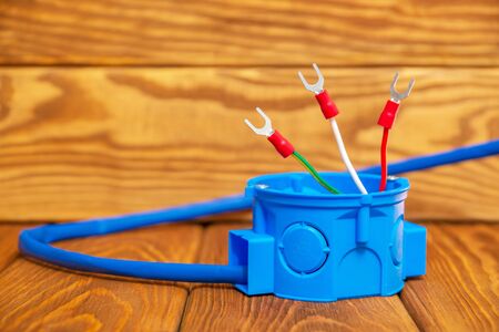 Electrical junction blue box with cable wire usually used in the electric installation process