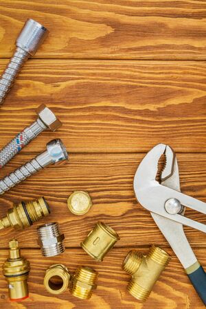 Tools of the master plumbing and accessories for various applications on vintage wooden boardsの写真素材