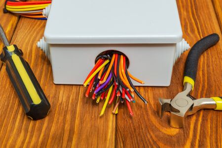 Electrical junction box with cables wire and tools usually used in the electric installation processの写真素材