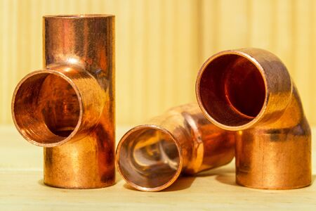 Copper water pipe fittings for soldering on wooden board plumbing conceptの写真素材