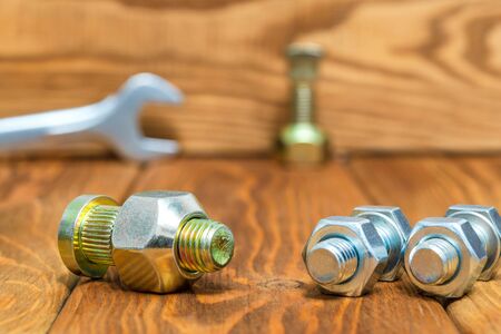 New metal nuts and bolts on wooden vintage boards close up