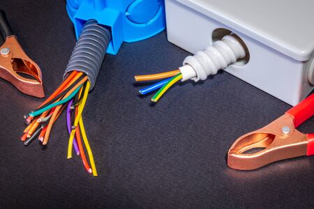 Spare parts, tool and wires for replacement or repair of electrical equipment on black background