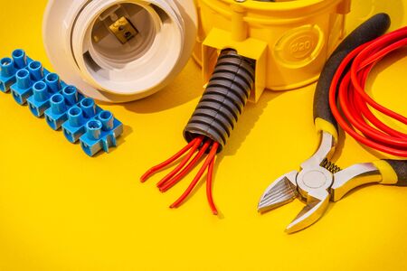 Spare parts, tool and wires for replacement or repair of electrical equipment on yellow backgroundの写真素材