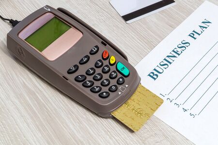 Payment terminal with card for receiving money on office desk top viewの写真素材
