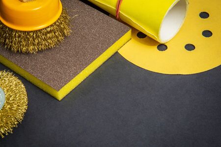 Big set of abrasive tools and yellow sandpaper on black background, wizard is used for grinding itemsの写真素材