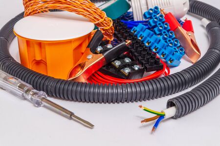Kit spare parts and tools for electrical repairs in home or office on gray backgroundの写真素材