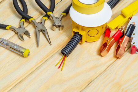 Kit spare parts and tools for electrical prepared before repair or setting on wooden boardsの写真素材