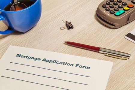 Mortgage agreement form blank is prepared for filling on table in an officeの写真素材