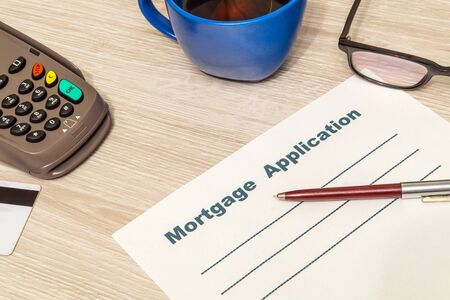 Mortgage agreement form blank is prepared for filling on table in an officeの写真素材