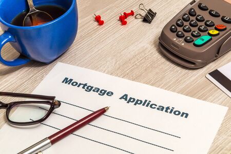 Mortgage agreement form blank is prepared for filling on table in an officeの写真素材