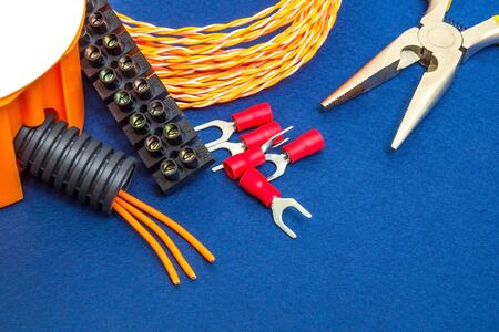 Kit spare parts and tools, wires for electrical prepared before repair or setting on a blue backgroundの写真素材