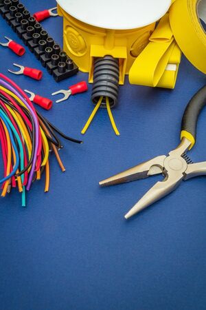 Kit spare parts and tools, wires for electrical prepared before repair or setting on a blue backgroundの写真素材