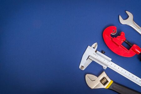 Set of tools on a blue background prepared by professional master before repair or construction