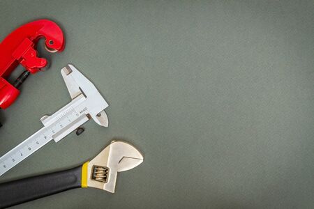 Set of tools for plumber on a dark workshop table prepared by professional master before repair or constructionの写真素材