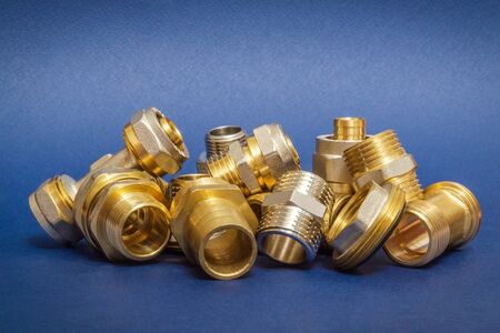 Many brass fittings is often used to connect for water and gas installations on a blue backgroundの写真素材