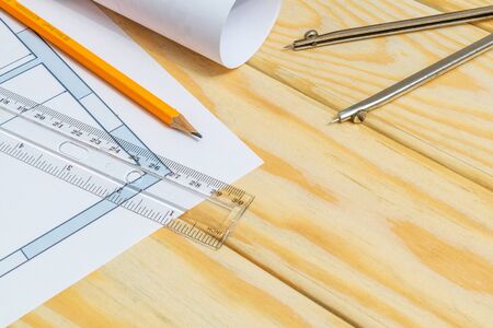 Rolled house diagrams and accessories for drawing lying on construction drawing. Drawings and accessories for projects engineer jobsの写真素材
