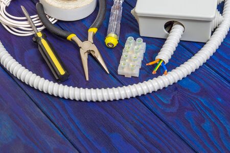 Kit spare parts and tool for electrical prepared before repair or setting on a blue wooden planks