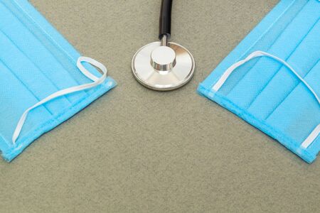Medical surgical doctor mask, flu and corona virus protection isolated with stethoscope on gray...