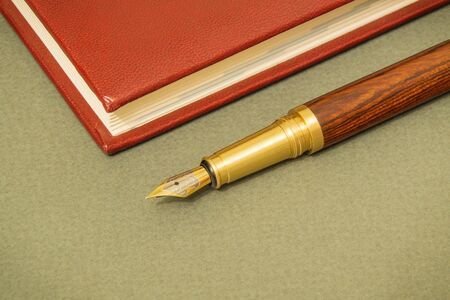 Office still life dark table with notebook and gilt pen businessman prepare for notesの写真素材