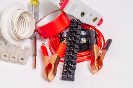 Kit spare parts and tool for electrical repairs in home or office on gray background