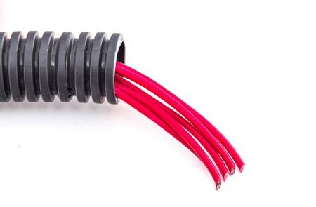 Corrugated pipe with red cables isolated on white background, electrical installation and home...