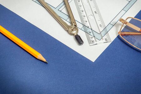 House diagrams and accessories for drawing lying on construction drawing and blue workshop table for projects engineer jobsの写真素材