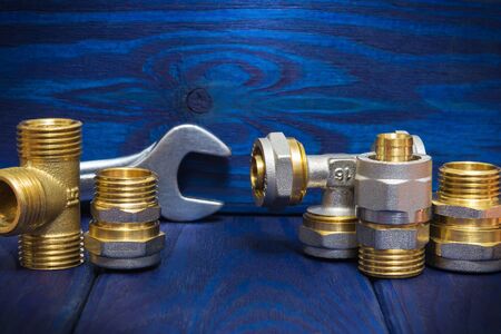 Brass fittings plumbing supplies on vintage blue boards used in water or gas piping