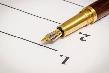 Stylish pen lies on a sheet of notes with numbers one and twoの写真素材