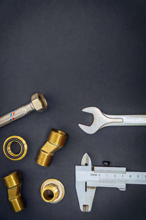 Set of tool and spare parts for plumbing isolated on black background with space for advertisingの写真素材