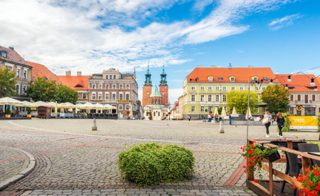 Street view in city center and Cathedral Basilica of the Assumption of Blessed Virgin Mary and St. Adalbert: Gniezno / Poland - October 04, 2020のeditorial素材