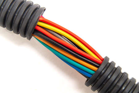 Electric wires in a protective case of different colors on white background. Used to connect to...