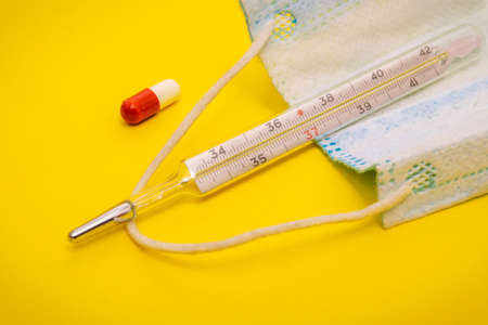 Set for flu treatment pills, capsules, thermometer, protective surgical mask. Epidemic and virus...