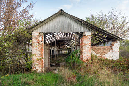 Old abandoned rural farm in ruins entrance viewの写真素材