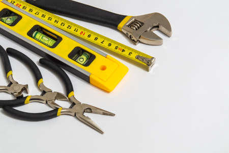 Tools for master builder on gray background stacked after work