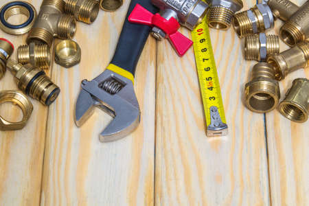 Plumbing spare parts and adjustable spanner close up on woodmen boardsの写真素材