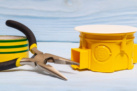 Yellow electrical junction box and tool usually used in the electric installation processの写真素材