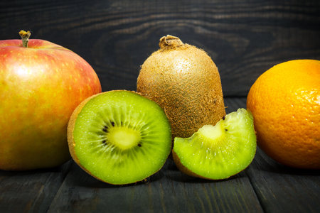 Set of fruits on a vintage black table for composing a diet and supply of vitaminsの写真素材